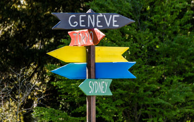 Close-up of road sign against trees