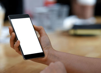Midsection of man using mobile phone