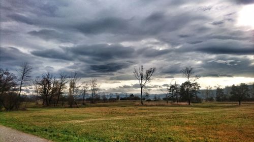 Scenic view of landscape against dramatic sky