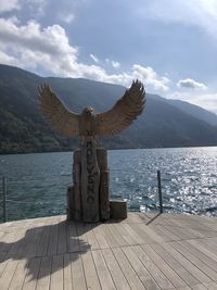 Sculpture by sea against sky