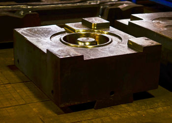 Close-up of lit tea light candles on table in temple