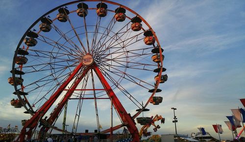 Low angle view of ferris wheel against sky