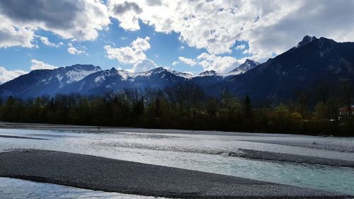 Scenic view of mountains against cloudy sky
