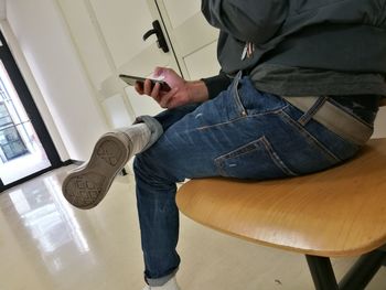 Low section of man standing at home