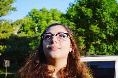 Thoughtful woman wearing eyeglasses looking up