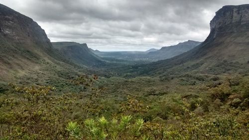 Scenic view of mountains against cloudy sky