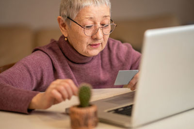 Senior man using laptop at home