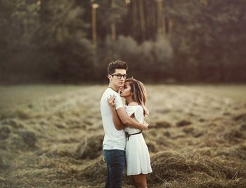 Couple hugging on field