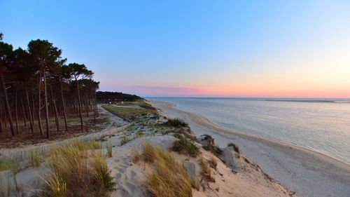 Scenic view of beach against sky during sunset