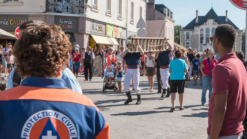 Rear view of people on street in city