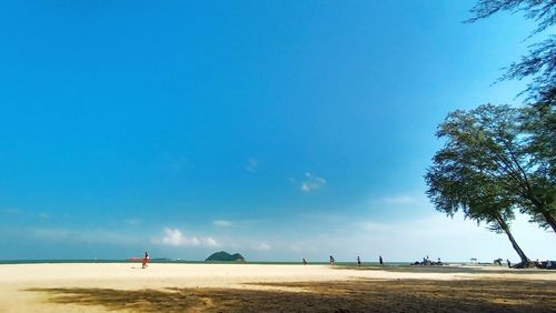 Scenic view of beach against blue sky