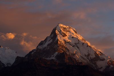 Scenic view of snowcapped mountains against sky during sunset