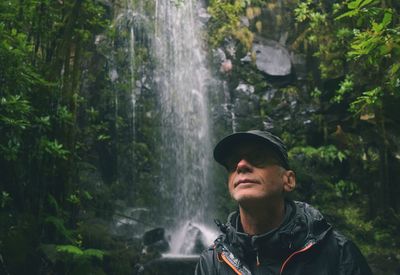 Man against waterfall in forest