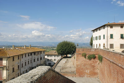 Houses in town against sky