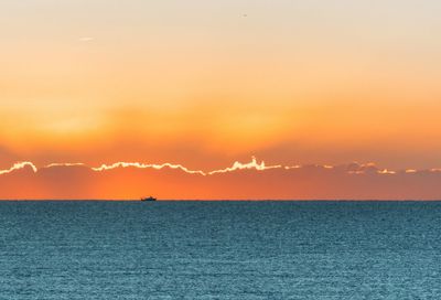 Scenic view of sea against romantic sky at sunset