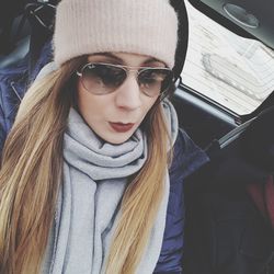 Portrait of young woman in car