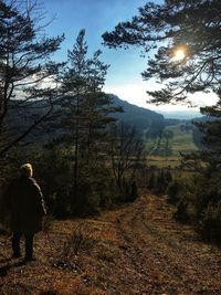 Rear view of man on land against sky