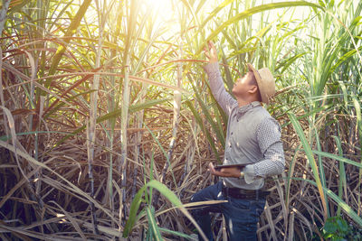 Side view of man standing in field