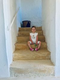 Portrait of girl sitting on staircase