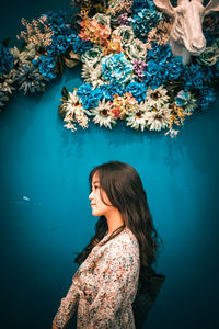 Woman standing against blue sky and water