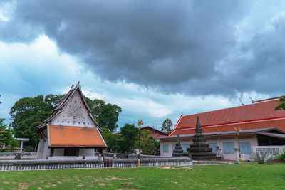 Exterior of house by building against sky