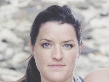 Close-up portrait of young woman with gray eyes