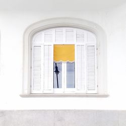 Full length of woman leaning on wall