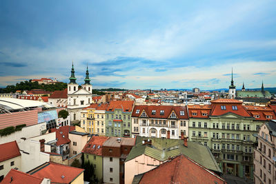 View of town against cloudy sky