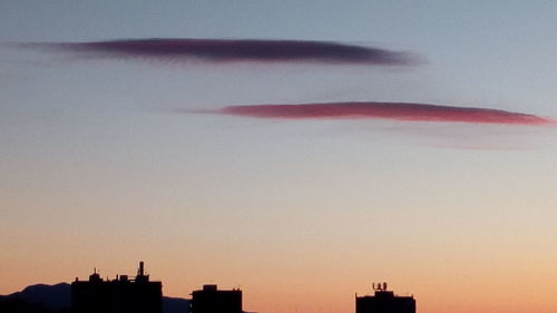 Low angle view of silhouette flag against sky during sunset