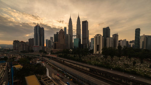 Panoramic view of city buildings against cloudy sky