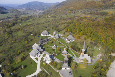 High angle view of trees and buildings in village