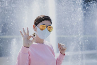 Portrait of woman wearing sunglasses standing outdoors