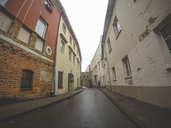 Street amidst city against sky