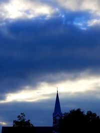 Low angle view of silhouette building against sky at dusk