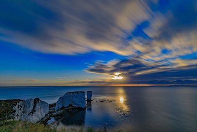 Scenic view of sea against sky at sunset