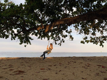 People on beach against sky