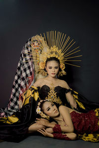 Portrait of woman sitting on sofa at home