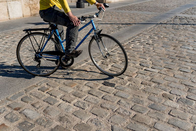 Unrecognizable man riding bicycle in the city