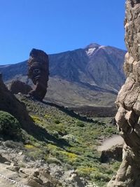 Low angle view of mountain against blue sky