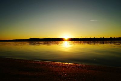 Scenic view of calm sea at sunset