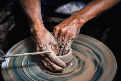 Close-up of artist making pot at workshop