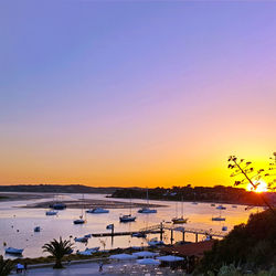 High angle view of sea against clear sky at sunset