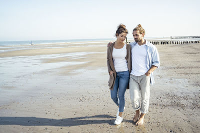 Full length of woman standing on beach