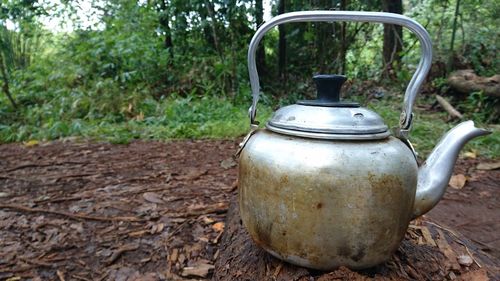 Close-up of old tea light on field