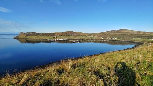 Scenic view of lake against clear blue sky