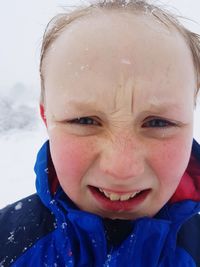 Portrait of smiling boy with snow
