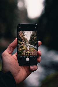 Close-up of hand holding smart phone taking a picture