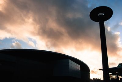 Low angle view of building against cloudy sky