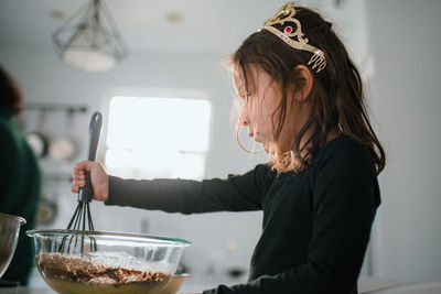 Rear view of girl having food