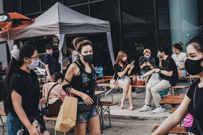 Group of people at music concert in city